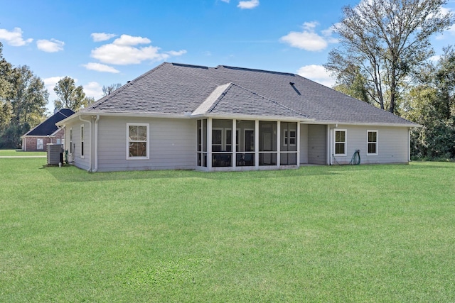 back of house with a sunroom, a yard, and central AC