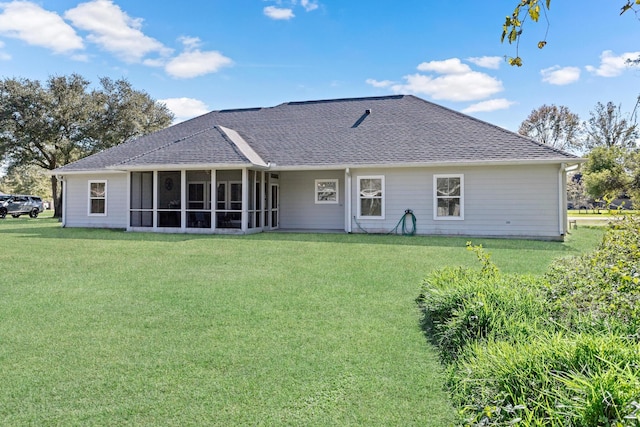 back of house featuring a yard and a sunroom