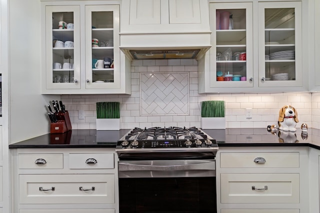 kitchen featuring white cabinetry, stainless steel gas range, and decorative backsplash