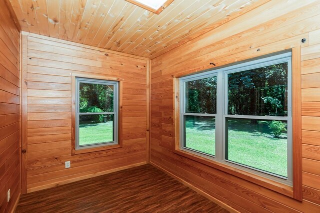 1905 Villa Rd, Kountze, TX 77625 - spare room with wood walls, dark wood-type flooring, wood ceiling, and healthy amount of natural light
