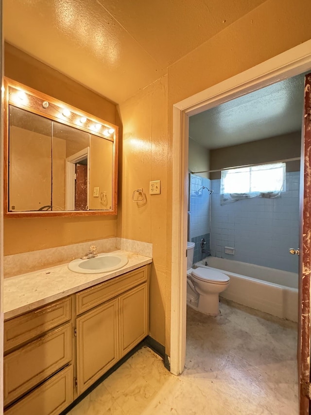 full bathroom featuring tiled shower / bath combo, toilet, and vanity