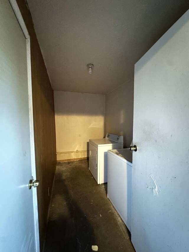 clothes washing area with washer and clothes dryer