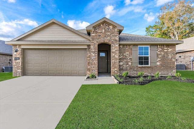 view of front of property with a garage, central air condition unit, and a front yard