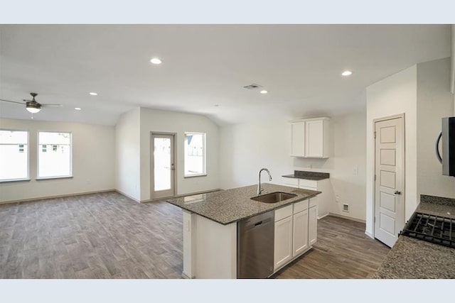 kitchen featuring a kitchen island with sink, sink, white cabinets, and stainless steel dishwasher