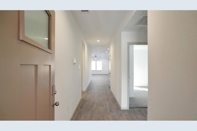 hallway with wood-type flooring