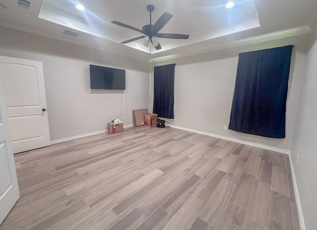 308 Long Leaf St, Silsbee, TX 77656 - unfurnished room featuring a raised ceiling, light wood-style floors, ceiling fan, and baseboards