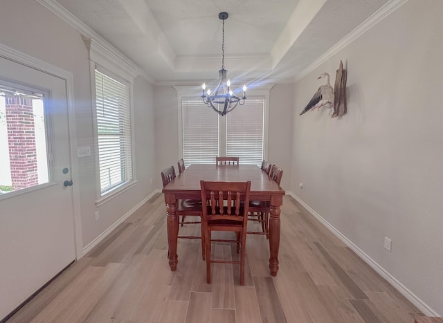 308 Long Leaf St, Silsbee, TX 77656 - dining space featuring a chandelier, light wood-style flooring, a tray ceiling, baseboards, and crown molding