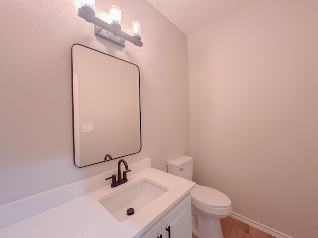 308 Long Leaf St, Silsbee, TX 77656 - bathroom featuring toilet, vanity, and baseboards