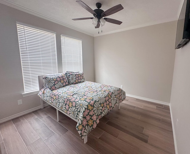 308 Long Leaf St, Silsbee, TX 77656 - bedroom with wood finish floors, baseboards, ornamental molding, ceiling fan, and a textured ceiling