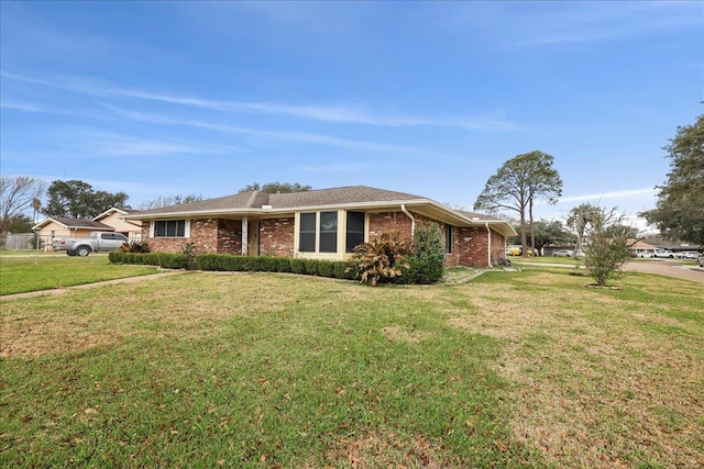 single story home with brick siding and a front lawn