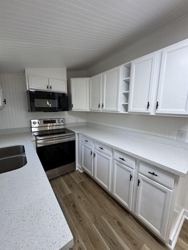 6250 Howe St, Groves, TX 77619 - kitchen featuring black microwave, electric range, open shelves, and white cabinetry