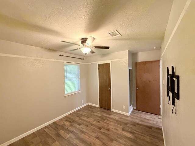 9410 Guy Cir, Beaumont, TX 77707 - unfurnished bedroom with wood finished floors, a textured ceiling, baseboards, a ceiling fan, and a closet