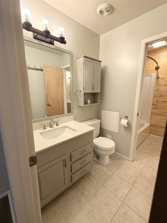 9410 Guy Cir, Beaumont, TX 77707 - full bath with vanity, toilet, tile patterned floors, a textured ceiling, and shower / tub combination