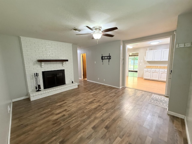 9410 Guy Cir, Beaumont, TX 77707 - unfurnished living room with ceiling fan, dark wood-type flooring, and baseboards