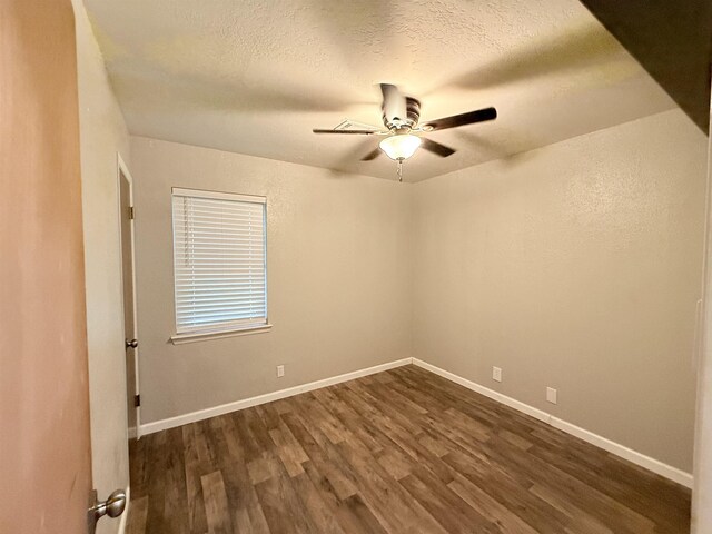 9410 Guy Cir, Beaumont, TX 77707 - empty room with dark wood finished floors, ceiling fan, baseboards, and a textured ceiling