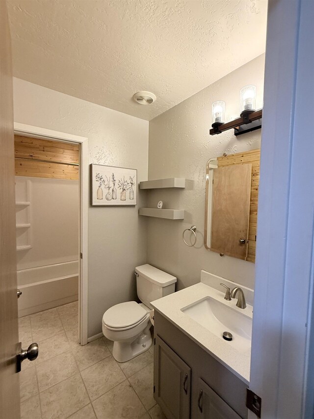 9410 Guy Cir, Beaumont, TX 77707 - full bath featuring a textured wall, a textured ceiling, vanity, toilet, and tile patterned flooring