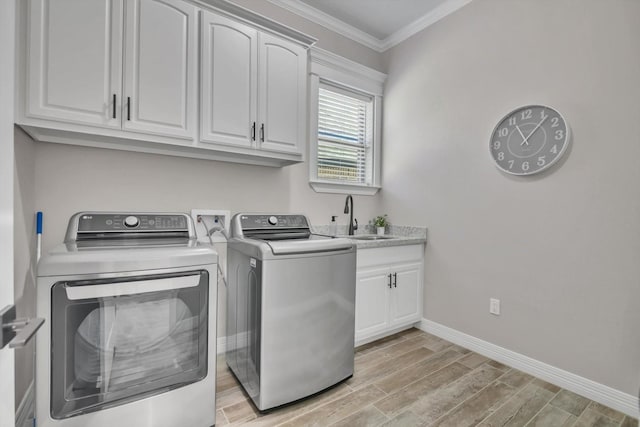 3435 Grey Hawk, Beaumont, TX 77707 - laundry area featuring separate washer and dryer, cabinet space, crown molding, light wood-style floors, and baseboards