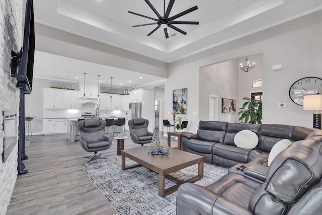3435 Grey Hawk, Beaumont, TX 77707 - living area featuring a raised ceiling, ceiling fan, light wood-type flooring, a chandelier, and recessed lighting