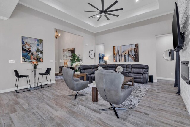 3435 Grey Hawk, Beaumont, TX 77707 - living room with a tray ceiling, a ceiling fan, wood finished floors, recessed lighting, and crown molding