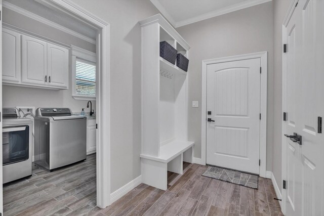 3435 Grey Hawk, Beaumont, TX 77707 - mudroom with ornamental molding, light wood-type flooring, washing machine and clothes dryer, baseboards, and a sink