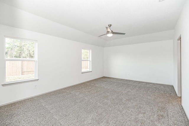 spare room with ceiling fan and carpet