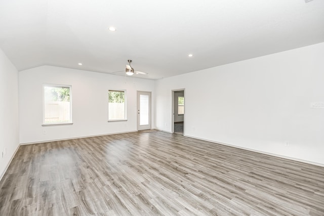 unfurnished living room featuring ceiling fan, light hardwood / wood-style floors, and lofted ceiling