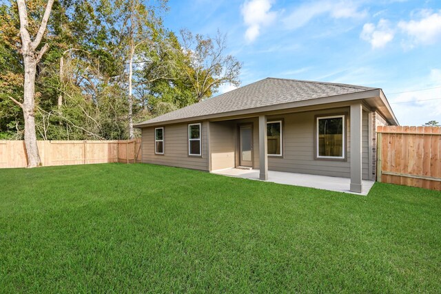 back of property featuring a patio area and a yard