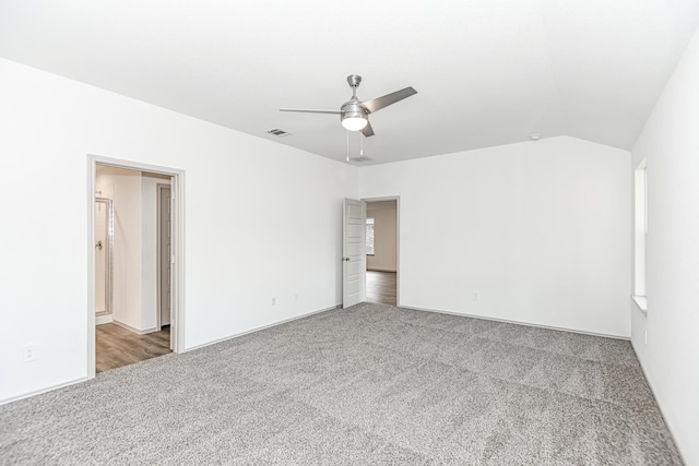 spare room with dark colored carpet and ceiling fan