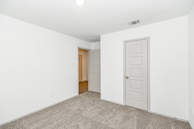 spare room featuring light colored carpet