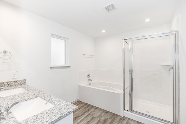 bathroom with hardwood / wood-style flooring, vanity, and separate shower and tub