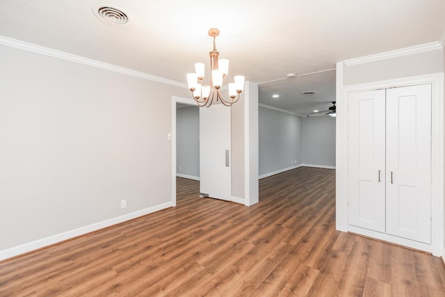 unfurnished dining area with ceiling fan with notable chandelier, dark hardwood / wood-style floors, and ornamental molding