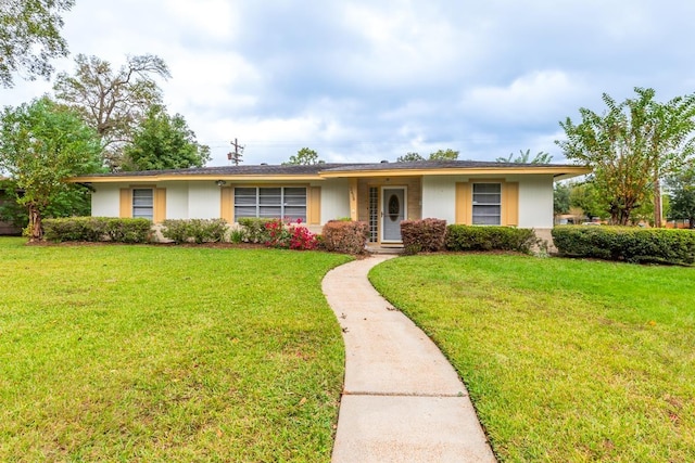 ranch-style home with a front lawn