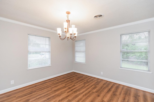 unfurnished room with ornamental molding, dark wood-type flooring, plenty of natural light, and a notable chandelier