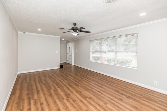 empty room featuring dark hardwood / wood-style flooring, a textured ceiling, ceiling fan, and crown molding