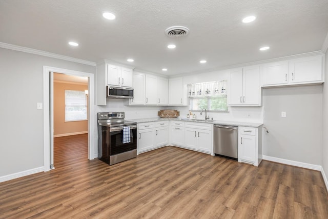 kitchen with white cabinets, stainless steel appliances, dark wood-type flooring, and sink