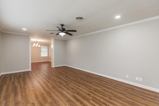 spare room with a textured ceiling, ceiling fan with notable chandelier, dark hardwood / wood-style floors, and ornamental molding