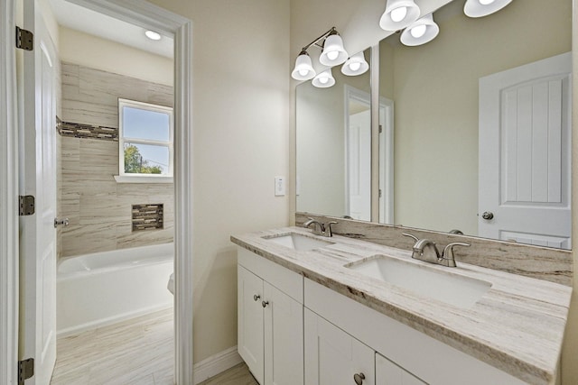 bathroom with vanity and tiled shower / bath