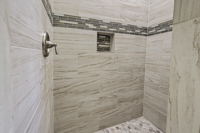 bathroom with a tile shower