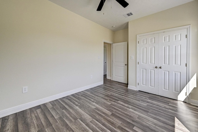 unfurnished bedroom featuring hardwood / wood-style flooring, ceiling fan, and a closet