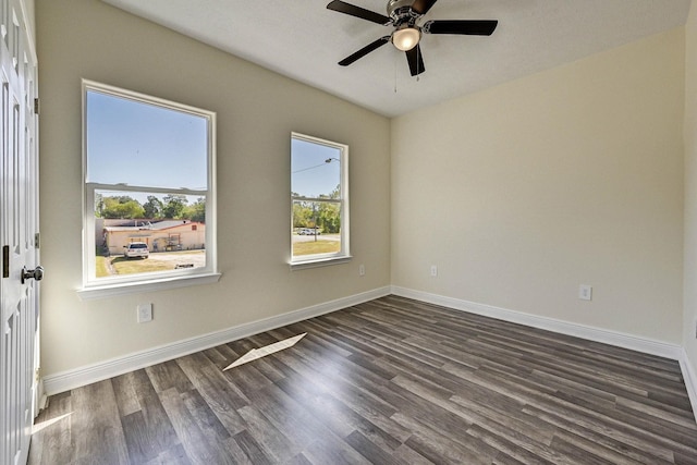 unfurnished room with dark hardwood / wood-style floors and ceiling fan