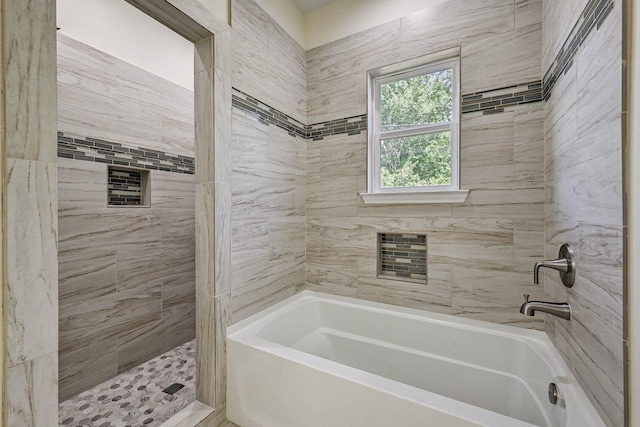 bathroom featuring independent shower and bath