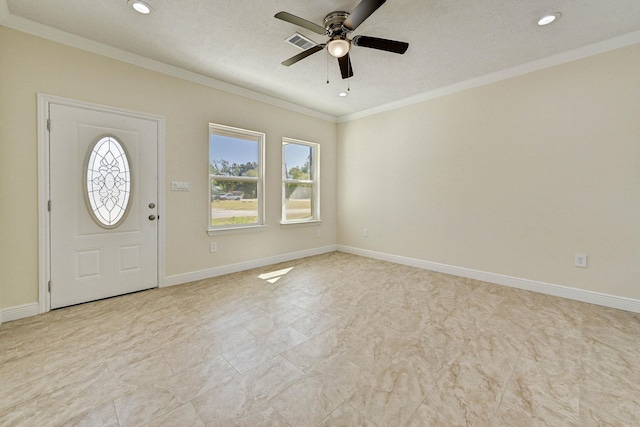 foyer with ceiling fan and ornamental molding