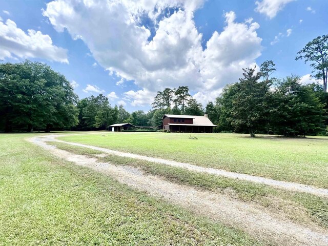1205 Douglas St, Vidor, TX 77662 - view of green lawn featuring driveway