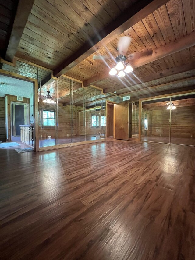 1205 Douglas St, Vidor, TX 77662 - spare room with a wooden ceiling with exposed beams, wood finished floors, ceiling fan, and wood walls