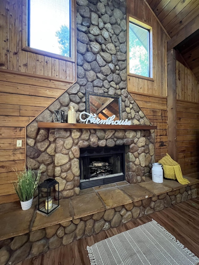 1205 Douglas St, Vidor, TX 77662 - detailed view of wood finished floors, a stone fireplace, and wooden walls