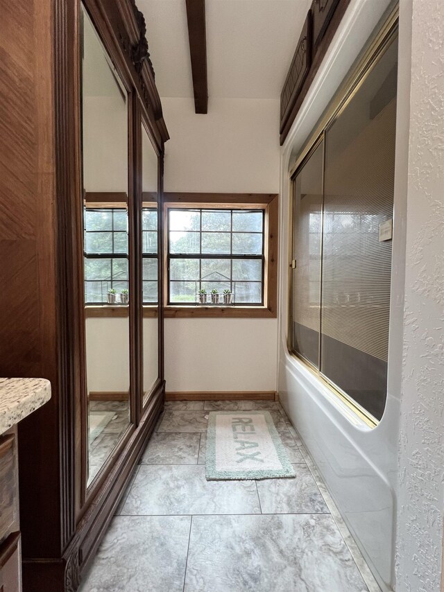 1205 Douglas St, Vidor, TX 77662 - bathroom featuring beam ceiling and shower / bath combination with glass door