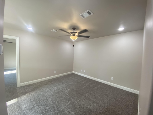 unfurnished room featuring dark colored carpet and ceiling fan