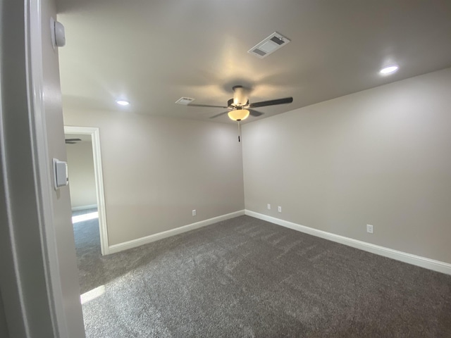 unfurnished room featuring dark colored carpet and ceiling fan