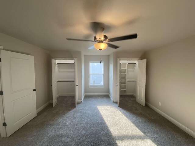 unfurnished bedroom featuring dark carpet and ceiling fan