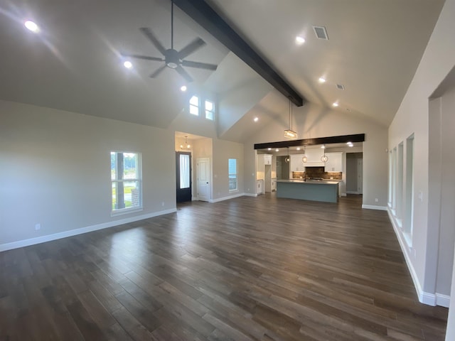 unfurnished living room with ceiling fan with notable chandelier, beam ceiling, dark wood-type flooring, and high vaulted ceiling